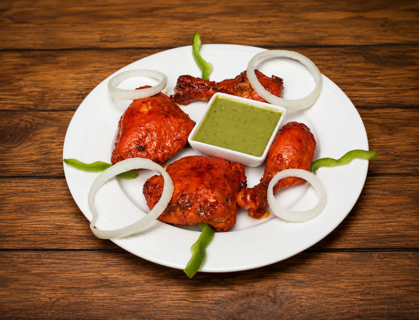 Halal tandoori chicken roasted in the clay oven at Charisma Of India Winnipeg